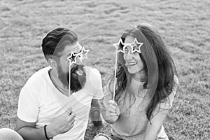 Fun ideas. Funny couple in love relaxing on green grass. Happy couple having fun with prop glasses on sticks. Sensual