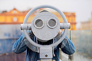 Fun ideas. man looks through his binoculars on the lookout closeup
