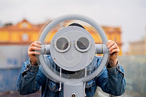 Fun ideas. man looks through his binoculars on the lookout closeup