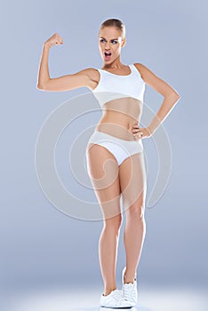 Fun image of a woman displaying her biceps