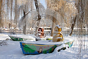 Fun kids boating architectures in a park in winter