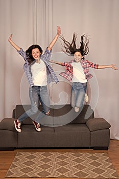 Fun leisure at home. girls party at home. happy sisters jump in freedom sense. mother and daughter having fun on weekend