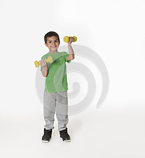 Fun little boy working out with weights