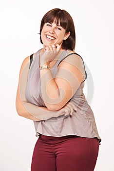 She is a fun loving girl. Portrait of a happy young woman laughing on a white background.