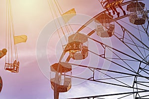 Fun in the lunapark, people on the rollercoaster and big wheel, susnet photo