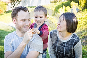 Fun Mixed Race Family Having Fun Outside on the Grass