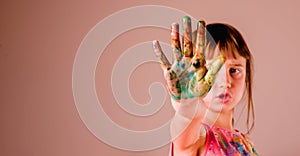 Fun pastime, art and baeuty concept. Colorful painted hands of beautiful young girl