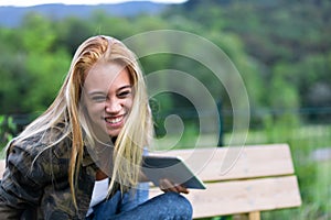 Fun playful young woman laughing at the camera
