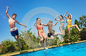 Fun in the pool group of kids jump inside water photo
