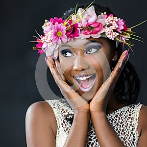 Fun portrait of attractive african bride with flower garland.