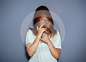 Fun portrait of a woman hiding behind her hair