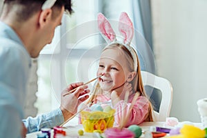 It is so fun preparing for Easter with dad.Dad and his little daughter together have fun while preparing for Easter holidays