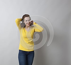 Fun 20s girl putting her hair in shape for the photo shot