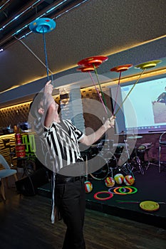 Fun with Spinning Plates .balancing a spinning plate. A collection of spinning yellow, blue, red pink plates