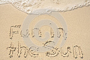 Fun in the Sun Written in Sand on Beach