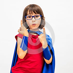 Fun superhero child raising her gifted fingers for critical mindset