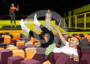 Fun in a trampoline center - after jumping on a trampoline, man fell onto soft, safe filler cubes