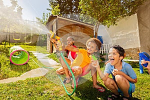 Fun with water guns and garden hose sprinkler