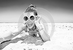 Happy young woman on seacoast taking selfie