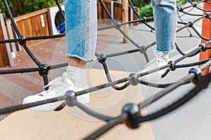 Fun woman in an adventure rope park at children playground