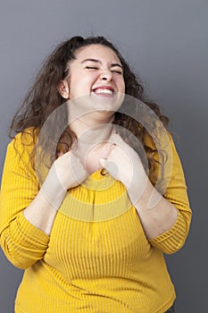 Fun xxl 20's woman expressing happiness with hands and face