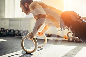 Functional fitness workout at the gym with rings push up. focus on rings