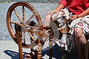 Functional historical spinning wheel used for thread making deemonstrated on festival of medieval and traditional crafts