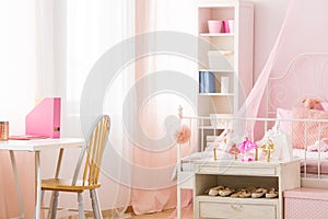 Functional pink room with bed photo