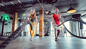 Functional training with battle rope in crossfit gym