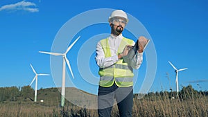 Functioning wind turbines with an energetics expert working near them