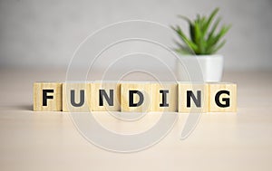 Funding Word Written In Wooden Cube, business concept.