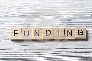 FUNDING word written on wooden cubes. Finance Concept. Money