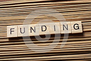 FUNDING word written on wooden cubes. Finance Concept. Money