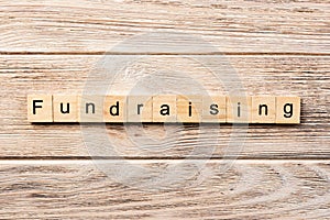 Fundraising word written on wood block. fundraising text on table, concept