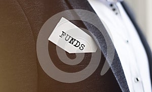 FUNDS word on white paper in a pocket of businesman jacket