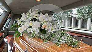 Funeral casket in a hearse or chapel or burial at cemetery