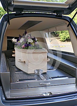 Funeral casket in a hearse or chapel or burial at cemetery