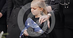 Funeral, cemetery and girl with American flag for veteran for respect, ceremony and memorial service. Family, depression