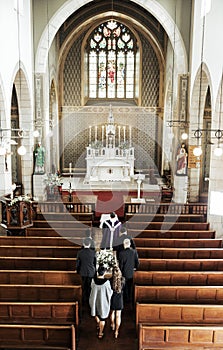 Funeral, church and people walking together to carry a coffin after a death or loss while inside for memorial service