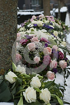 Funeral flowers arrangement in the snowon a cemetery