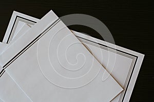 Funeral notice (card) and envelopes on the black table