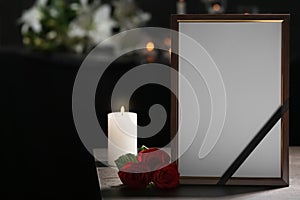 Funeral photo frame with black ribbon, roses