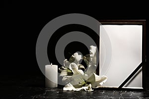 Funeral photo frame, burning candle and lily flowers