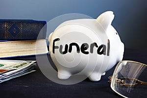 Funeral plan written on a side of piggy bank. photo