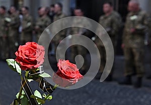 A funerals of Ukrainian servicemen killed during Russia`s invasion of Ukraine. Soldier holds flowers