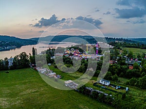 Funfair by dam Lake in Brno from above at dusk, Czech Republic