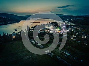 Funfair by dam Lake in Brno from above at dusk, Czech Republic