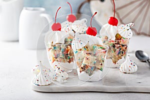 Funfetti cake trifle with meringue kisses and a cherry on top