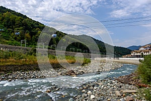 Funicular over the river in the mountains against the backdrop of the forest.