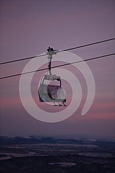 Funicular panorama, pink sky magic. Winter holiday in the mountains. Beautiful resort.